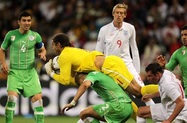 England s David James (C) saves the ball against Madjid Bougherra of Algeria during the 2010 World Cup Group C match against Algeria in Cape Town 