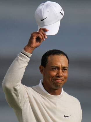 Tiger Woods (USA) doffs his hat to the fans on the 18th green on the day three of the U.S. Open in Pebble Beach, California on June 19, 2010.  PBP2010061923