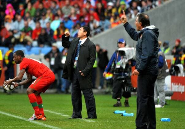 Head coach of the Democratic People s Republic of Korea (DPRK) Kim Jong-Hun (C) and Carlos Queiroz (R), head coach of Portugal, react during the 2010 World Cup group G soccer match at Green Point stadium in Cape Town 
