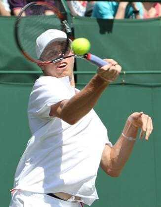 USA s Sam Querrey plays a forehand in his match on the second day of the Wimbledon championships in Wimbledon on Tuesday June 22 2010.  LON2010062202g
