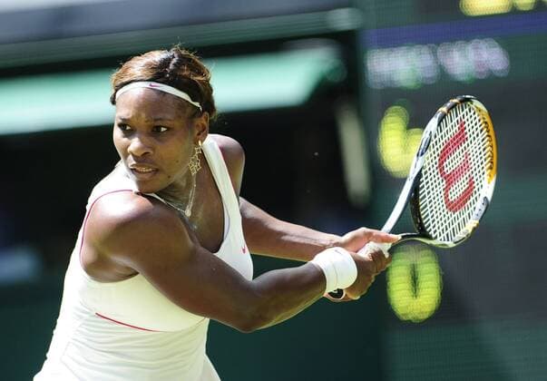 Serena Williams of the United States returns a shot during her first round women s singles match in the 2010 Wimbledon Championships, in London - 