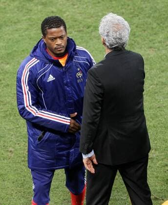 France s Patrice Evra (L) with head coach Raymond Domenech FIFA World Cup 2010 Group A France EDITORIAL USE ONLY. No use with unauthorised audio, video, data, fixture lists, club league logos or live services. Online in-match use limited to 120 images, no video emulation. No use in betting, games or single club league player publications.