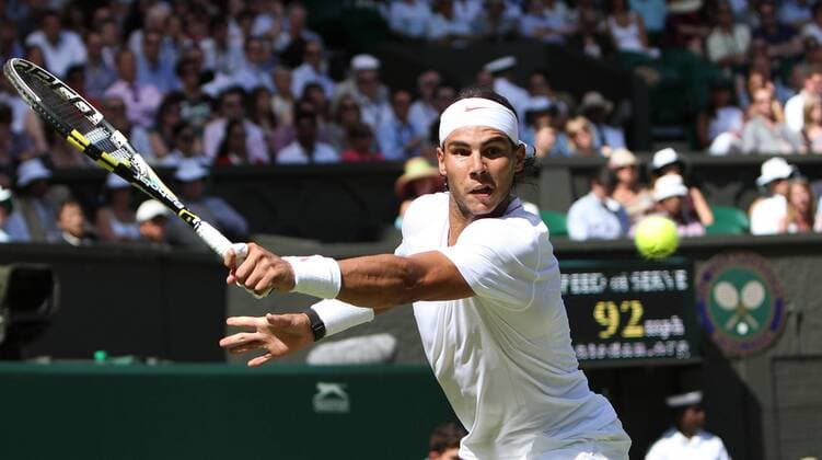 Spain s Rafael Nadal plays a backhand during his match against Japan s Kei Nishikori on the second day of the Wimbledon championships in Wimbledon on Tuesday June 22 2010.  LON2010062217