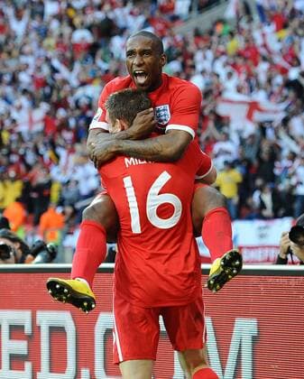 Football - 2010 FIFA World Cup - Slovenia vs. England, England s Jermain Defoe (up) celebrates with James MILNER scoring their opening goal at the Nelson Mandela Bay Stadium, Port Elizabeth 