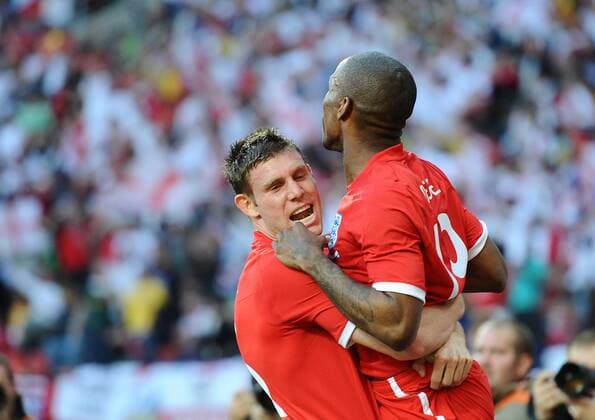 Football - 2010 FIFA World Cup - Slovenia vs. England, England s Jermain Defoe (R) and James Milner celebrate scoring their opening goal at the Nelson Mandela Bay Stadium, Port Elizabeth 