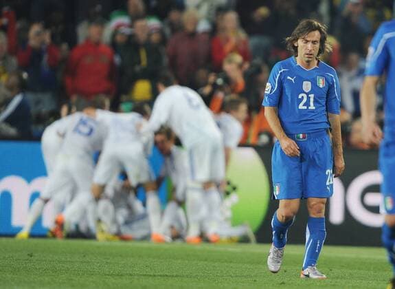 Football - World Cup 2010 Italy v Slovakia (white) 24 06 2010: Andrea Pirlo (Italy) walks away as the Slovakian team celebrate goal no. 2. 