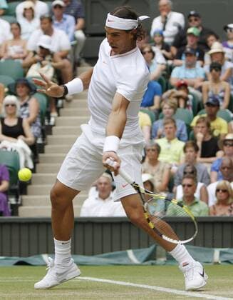 Spain s Rafael Nadal plays against Germany s Philip Petzschner on the sixth day of the Wimbledon championships in Wimbledon on June 26, 2010.  LON2010062609