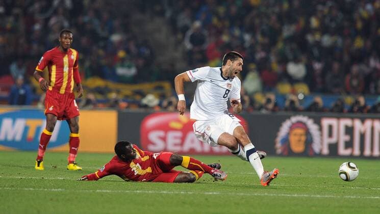 Clint Dempsey (R) of USA fights for the ball with Kwadwo Asamoah of Ghana during the 2010 FIFA World Cup soccer match between USA and Ghana at Royal Bafokeng Stadium on June 26, 2010 in Rustenburg - - ZUMAgh1