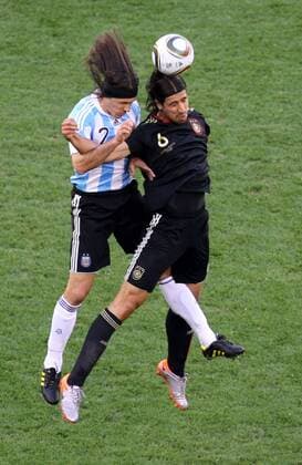 Sami Khedira (R) of Germany heads the ball with Martin Demichelis of Argentina during their 2010 World Cup quarterfinal soccer match at Green Point stadium in Cape Town on July 3, 2010. 