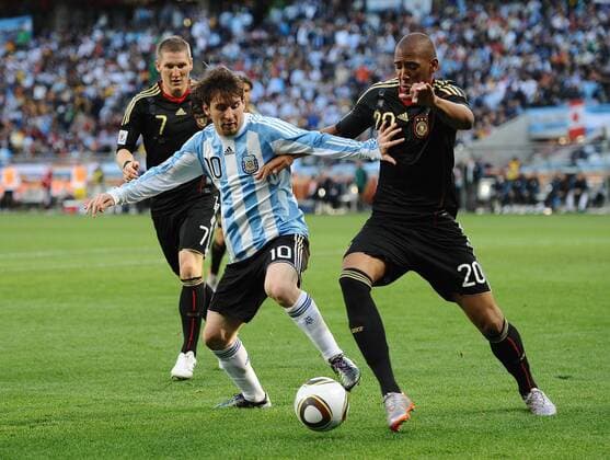 Football - 2010 FIFA World Cup - QuarterFinal - Argentina vs. Germany Lionel Messi of Argentina (L) and Jerome Boateng of Germany in action at Green Point Stadium, Cape Town 