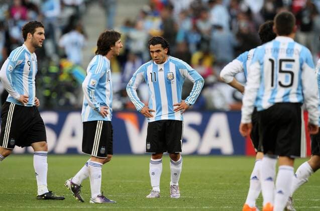 Argentina s Carlos Tevez (3L) looks on dejected FIFA World Cup 2010 QuarterFinals Argentina v Germany 3rd July, 2010 EDITORIAL USE ONLY. No use with unauthorised audio, video, data, fixture lists, club league logos or live services. Online in-match use limited to 120 images, no video emulation. No use in betting, games or single club league player publications.