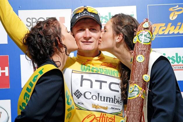 Andre Greipel (GER Team HTC Columbia) - Podium - Leader Classification Overall - Event: Tour of Austria 2010 - Stage 1 - Dornbirn to Bludenz 157.9 km - Date: 04.07.2010 - Location: Bludenz - Vorarlberg - Austria - Europe - Contact o0 gelbes Trikot Jubel Freude Hostess Girl Kuss Siegerkuss Objekte Trophäe Wurst Salami