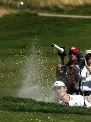 Justin Rose (England) sends sand flying as he blasts out of a sand trap on the 8th hole during final round play of the AT and T National at Aronimink Golf Club in Newtown Square, Pennsylvania on July 4, 2010. Rose finished with a par 70 for the day to win the tournament with a 10 under par 270.  PHI2010070405
