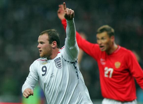 MOSCOW, England s Wayne Rooney (front) and Russia s Alexei Berezutsky gesture to their team-mates during their Euro qualifying soccer match against England at Luzhniki Stadium, Moscow. Russia won 2-1.  520429
