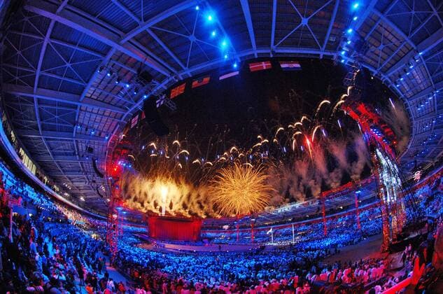 The Olympic flame burns as fireworks light up the sky during the opening ceremony of the 2006 Winter Olympics at the Olympic Stadium in Turin.  284490