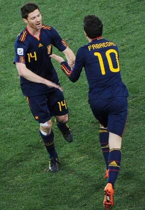 Xabi Alonso (L) of Spain claps hands with Cesc Fabregas during a substitution in the World Cup final against the Netherlands at Soccer City stadium in Johannesburg 
