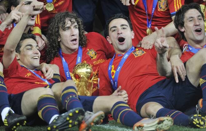 Football - World Cup Finals 2010 Spain v Netherlands ( orange ) 11 07 2010 Final: Spain players celebrate with the trophy R-L: Joan Capdevila, Xavi Hernandez, Carles Puyol, Jesus Navas  o0 Jubel Freude