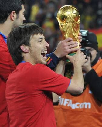 Football - World Cup Finals 2010 Spain v Netherlands ( orange ) 11 07 2010 Final: David Silva (Spain) ,with the World Cup trophy  o0 Jubel Freude