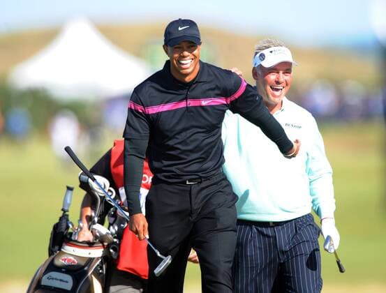 Tiger Woods (USA, L) and Darren Clarke (Northern Ireland) laugh together on the 11th hole on the third day of the Open championship in St.Andrews, Scotland on July 17, 2010.  LON2010071717 o0 Nordirland