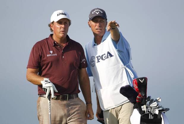 Phil Mickelson (USA) (L) talks with his caddie Jim Mackay on the 3rd tee during the first round of the 92nd PGA Championship at Whistling Straits in Kohler, Wisconsin on August 12, 2010.  BKX2010081217