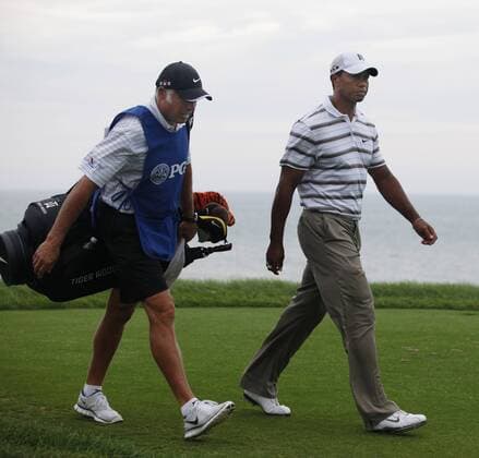 Tiger Woods (R) walks up the 4th fairway with his caddie Steve Williams during the second round of the 92nd PGA Championship at Whistling Straits in Kohler, Wisconsin on August 13, 2010. The second round was suspended due to darkness.  BKX2010081350