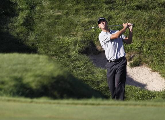 Martin Kaymer of Germany makes a chip shot onto the 18th green during the final round of the 92nd PGA Championship at Whistling Straits in Kohler, Wisconsin on August 15, 2010. Kaymer won a three-hole playoff by one stroke to win the tournament after finishing regulation play with a 11-under-par 277.  BKX2010081540