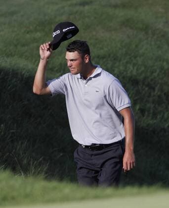 Martin Kaymer of Germany tips his hat to the crowd as he walks onto the 18th green during the final round of the 92nd PGA Championship at Whistling Straits in Kohler, Wisconsin on August 15, 2010. Kaymer won a three-hole playoff by one stroke to win the tournament after finishing regulation play with a 11-under-par 277.  BKX2010081541