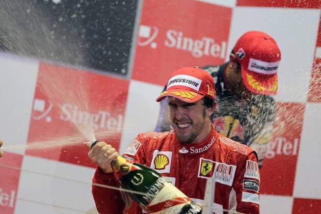 26 Sep 2010: Fernando Alonso of Ferrari celebrates on the podium after winning the Formula 1 Singtel Singapore Grand Prix held at Marina Bay Street Circuit in Marina Bay, Singapore. Icon3781009261380 o0 Freude Sieg EDITORIAL USE ONLY