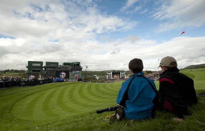 Golf - Ryder Cup 2010 - Practice Day 3 Two youngsters look on as the opening ceremony of the Ryder Cup takes place at Celtic Manor, Newport  o0 Fan Zuschauer