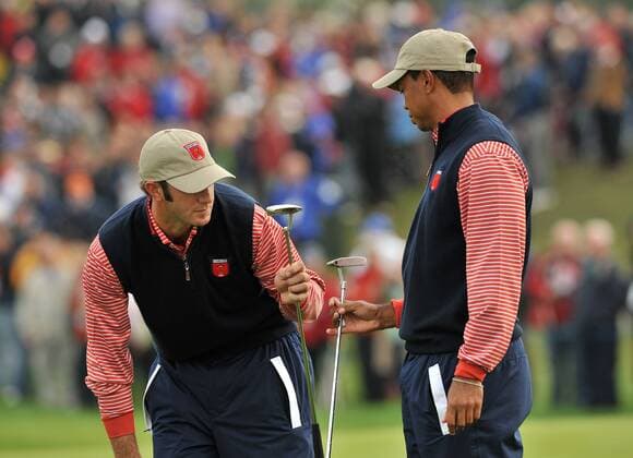 Golf - Ryder Cup 2010 - Practice Day 3 Tiger Woods r. and Dustin Johnson of the USA compare putters during practice at Celtic Manor, Newport 
