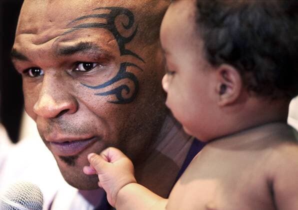 Feb. 20, 2003 - Tunica, - Mike Tyson (USA) speaks to the press as he holds his son, Miguel, at the Grand Casino Tunica Thursday. - ZUMAc51