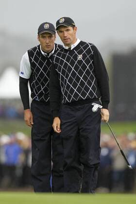 Golf - Ryder Cup 2010 - Day Three Padraig Harrington (IRL, R) and Ross Fisher (ENG) plan their putt at Celtic Manor, Newport 