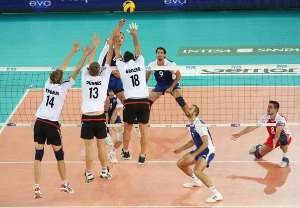 David Konecny of Czech Rep. spikes the ball over the German block by Robert Kromm (14), Christian DÃ¼nnes (13) and Georg Grozer (18) during the match Germany v Czech Republic of the third round of FIVB Men s Volleyball World Championship Italia 2010 at Palalottomatica in Rome, Italy on October 5th, 2010. xMarcoxMegax  ActionPlus20150351 Content restricted for UK based newspaper