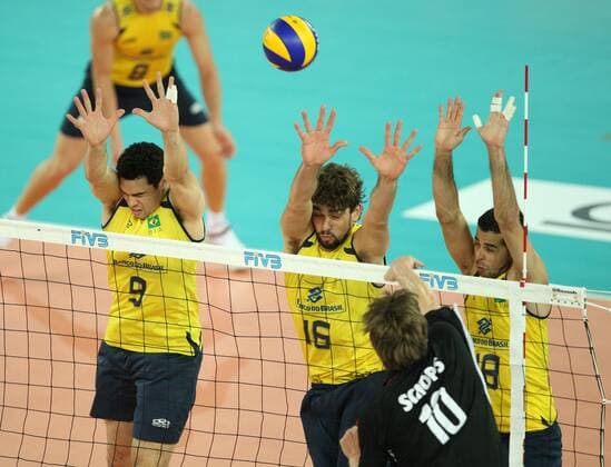 Schops Jochen of Germany (10) spikes the ball in front of the Brazilain block by Fabrico Nery Theo (9), Saatkamo Lucas (16) and Amaral Dante Guimaraes (18) Brazil (yellow) vs. Germany (black) xMarcoxMegax  ActionPlus11101146 Content restricted for UK based newspaper