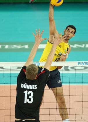 Amaral Dante Guimaraes (R) of Brazil spikes the ball while Dunnes Christian of Germany attempts to block Brazil (yellow) vs. Germany (black) xMarcoxMegax  ActionPlus11101147 Content restricted for UK based newspaper