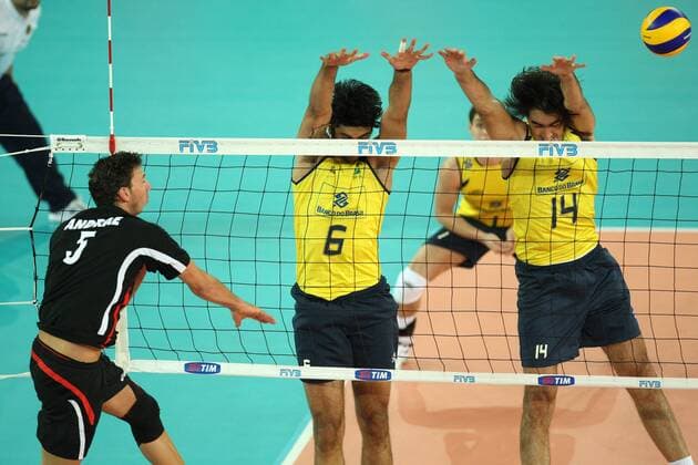 Andrae Bjorn (L) of germany spikes the ball over the Brazilian block by Vissotto neves Leandro (C) and Santana Rodrigo Brazil (yellow) vs. Germany (black) xMarcoxMegax  ActionPlus11101163