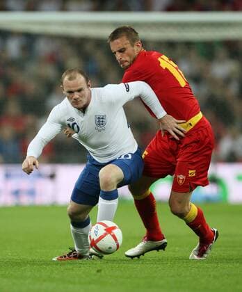 Englands Wayne Rooney (L) tussles with Montenegros Milorad Pekovic European Championship Qualifying Group G England v Montenegro 12th October, 2010 EDITORIAL USE ONLY. No use with unauthorised audio, video, data, fixture lists, club league logos or live services. Online in-match use limited to 120 images, no video emulation. No use in betting, games or single club league player publications.