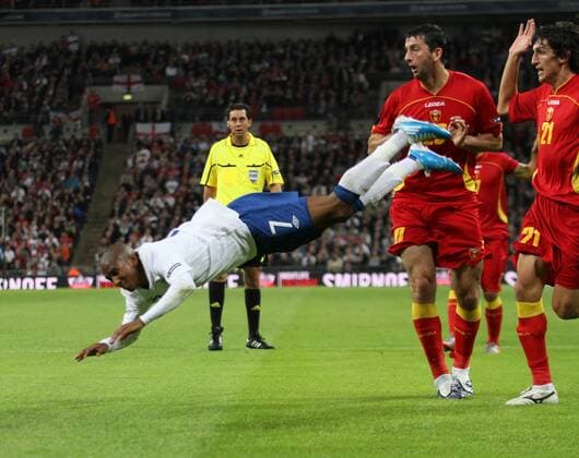 Englands Ashley Young (L) gets booked for this dive European Championship Qualifying Group G England v Montenegro 12th October, 2010 EDITORIAL USE ONLY. No use with unauthorised audio, video, data, fixture lists, club league logos or live services. Online in-match use limited to 120 images, no video emulation. No use in betting, games or single club league player publications.