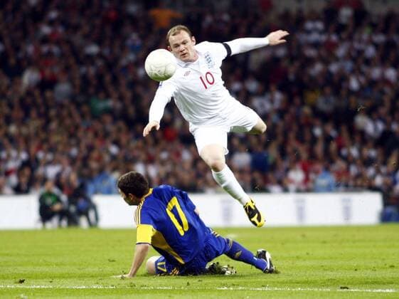 England s Wayne Rooney (R) tackled by Taras Mikhalik of Ukraine - World Cup Qualifer England v Ukraine at Wembley Stadium - 