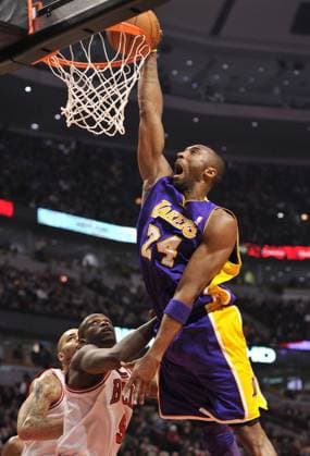 Los Angeles Lakers guard Kobe Bryant (L) dunks over Chicago Bulls forward Luol Deng during the first quarter at the United Center in Chicago on December 10, 2010.  CHI2010121001 o0 Basketball USA
