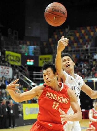 HONG KONG HONGKONG, Dec. 19, 2010 -- Fong Shing Yee (L) of Hong Kong basketball team fights with Erram John Paul of the Philippines during the 18th Kung Sheung Cup International Basketball Invitation Championship in Hong Kong, Dec. 19, 2010. Hong Kong of China won 61-45. --- 