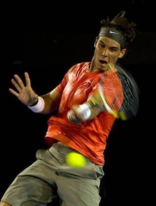 Rafael Nadal of Spain hits a shot during the third round match of men s singles at the Australian Open tennis tournament in Melbourne Jan. 22, 2011. 