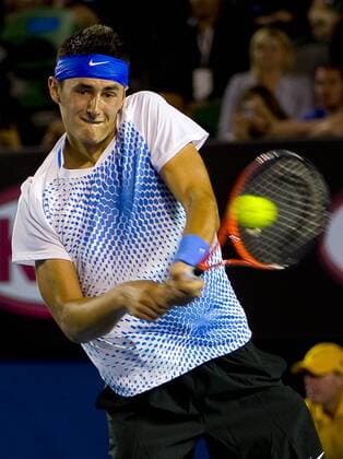 Bernard Tomic of Australia hits a shot during the third round match of men s singles at the Australian Open tennis tournament in Melbourne Jan. 22, 2011. 