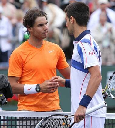 Rafael Nadal of Spain (L) meets Novak Djokovic of Serbia at the net after their mens final match at the BNP Paribas Open in Indian Wells, California on March 20, 2011.  IDW20110320744