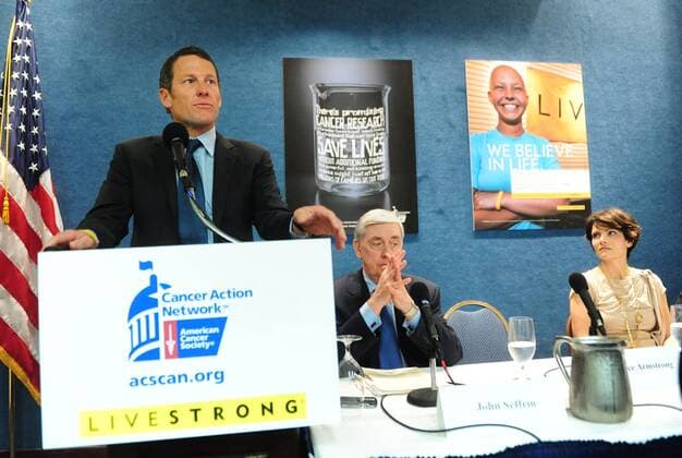 Lance Armstrong (USA, L) delivers remarks at a press conference held to urge Congress to oppose cuts to cancer research and prevention programs, in Washington on March 24, 2011. Armstrong was joined by John Seffrin, PhD, CEO, American Cancer Society Cancer Action Network, and Tracy Elliman, former National Cancer Institute clinical trial participant.  WAP20110324313