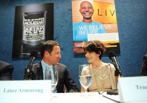 Lance Armstrong (USA) talks to Tracy Elliman, former National Cancer Institute clinical trial participant, at a press conference held to urge Congress to oppose cuts to cancer research and prevention programs, in Washington on March 24, 2011. Armstrong was joined by Tracy Elliman, former National Cancer Institute clinical trial participant. WAP20110324314