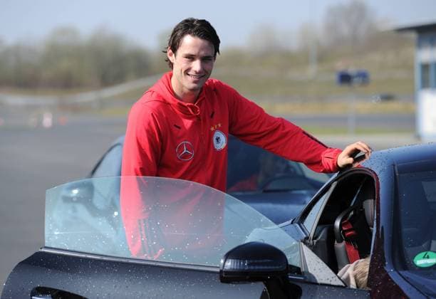 Lacht am Mercedes-Benz SLK 350 BlueEFFICIENCY : Christian TRAESCH (Deutschland). Fussball: Driving-Experience Fahrsicherheitstraining der deutschen Fussball Nationalmannschaft der Männer auf der Strecke des ADAC-Fahrsicherheitszentrum in Grevenbroich, 28.03.2011. Poolfoto.
