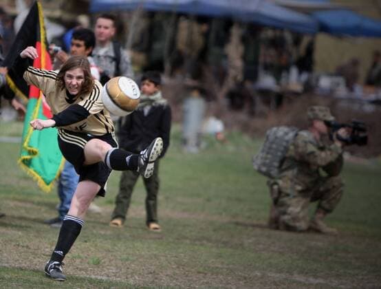 A player of NATO-led International Security Aid Force women s soccer team kicks out the ball during a friendly match against Afghan women s national soccer team in Kabul, capital of Afghanistan, on April 1, 2011. The match ended with a 0-0 tie.  o0 Aktion Militär Soldat kurios