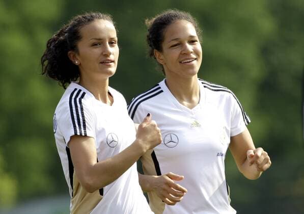 Germany s Celia Okoyino da Mbabi (R) and Fatmire BAJRAMAJ laugh during the training session of the german women s national team, Netcologne Stadium in Koeln on April 22., 2011. Mika
