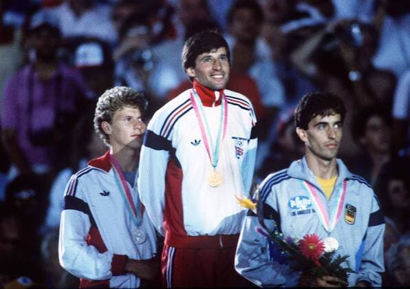 Sebastian Coe (GBR) on the podium with his gold Medal. Steve Cram (left), Jose Manuel Abascal (ESP, R) . Mens 1500m Final; 11 08 1984 1984 Los Angeles Olympics  o0 Leichtathletik